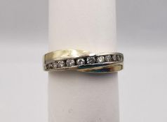 A 14 carat yellow and white gold diamond set twist half eternity ring. Set with ten round