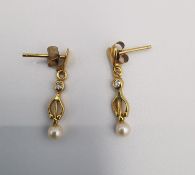 A pair of yellow metal (tests higher than 9ct) cultured pearl and diamond drop earrings. Each