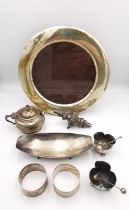 A collection of silver items, including a circular silver easel picture frame, two napkin rings, a