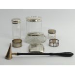 A silver and wooden handled candlesnuffer, London 1961, silver topped dressing table bottles, a