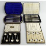 A cased set of six coffee bean spoons, six seal end silver coffee spoons and two cased sets of