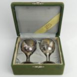 A cased pair of Oriental silver egg cups, 70 grams. 82 mm high. UK Postage £12.