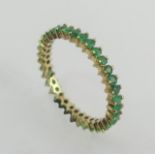 9ct gold emerald full eternity ring, 2.1 grams. Size T, 3.2 mm wide. UK Postage £12.