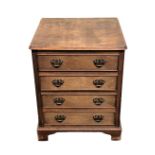 Small wooden chest of four drawers with brass swan neck handles. 61 h x 49 w x 46 cm deep.