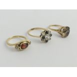 9ct gold garnet and diamond ring, 9ct gold smokey quartz ring and a 9ct gold blue and white stone