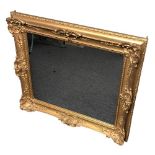 Early 20th century ornate gilt framed wall mirror. 90 x 78 cm. Collection only.
