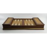 A wooden backgammon set, complete with instructions and yellow and white metal metal counters. 37.