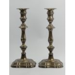 A pair of George V silver weighted silver candlesticks with detatchable sconces, Sheffield 1912.