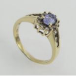 10ct gold tanzanite and diamond ring, 3.1 grams. Size P 1/2, 9.9 mm wide. UK Postage £12.