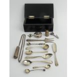 A silver mounted pin box containing small items of silver including a napkin clip. 113 grams. UK