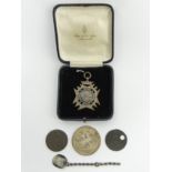 Victorian silver divers medal fob, a George III silver crown (very worn) and three further coins