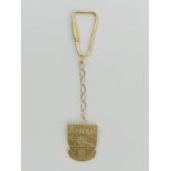 9ct gold arsenal key fob, 6.4 grams, 9.5 cm long. UK Postage £12.