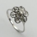 18ct white gold flower head design diamond set ring, 2.6 grams. Size P, 11.8 mm. UK Postage £12.