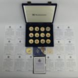 A case of 20 Westminster gold plate and enamel medallions commemorating Queen Elizabeth and Prince