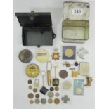A tin of various coins, medallions, badges and other items of interest. UK Postage £12.