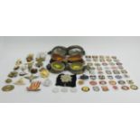 A tin of army and other badges along with three pairs of flying goggles. UK Postage £12.