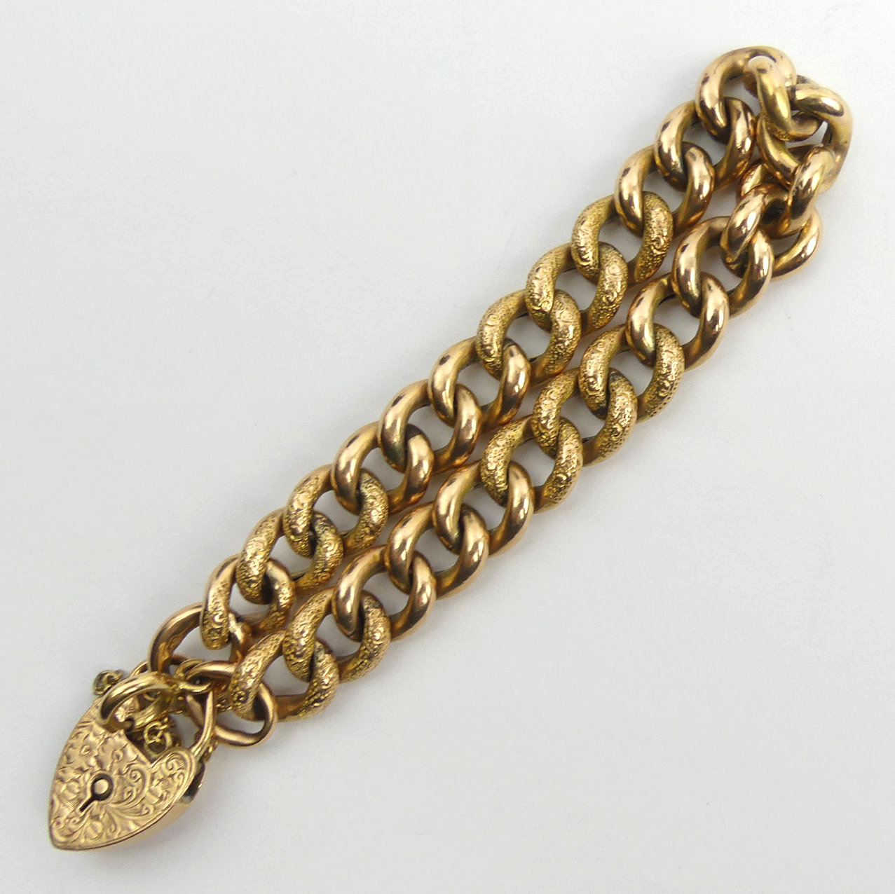 9ct gold textured and plain curb link gate bracelet, 18.6 grams. 10 mm wide. UK Postage £12.