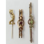 9ct gold peridot and seed pearl brooch, a 9ct gold garnet brooch and a 9ct gold golfing design stick