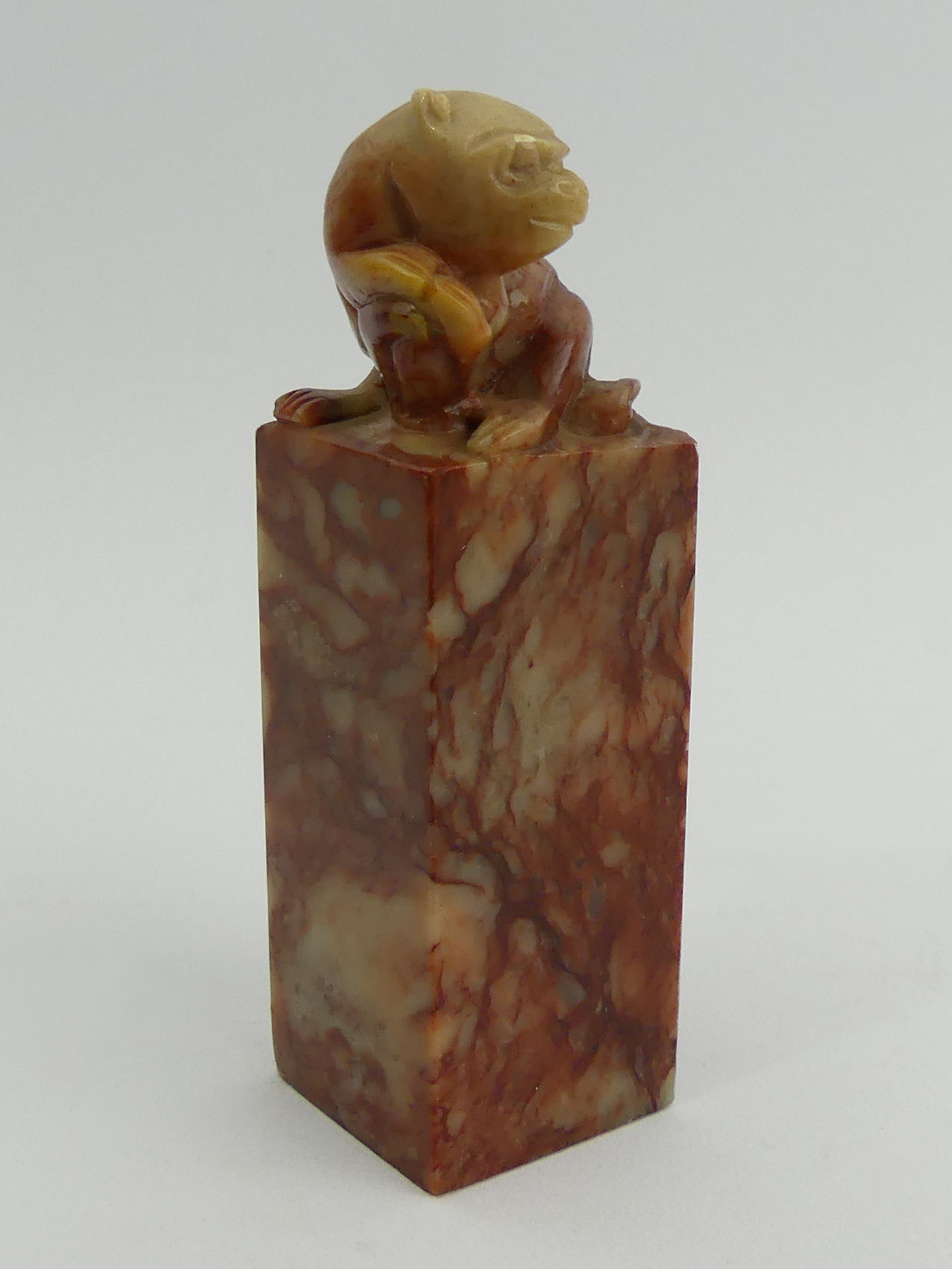 A Chinese carved soapstone seal with a monkey to the top. 9.5 cm. UK Postage £12.