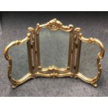 A vintage gilt framed tryptich dressing table mirror. 58 cm high. Postage not available.