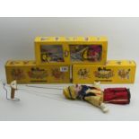 Three Pelham boxed puppets, The Caterpillar, The Clown and The Cowgirl along with a Pinnochio