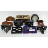 A bakelite clock, mahogany mantle clock and old tin money cash box, three old cameras and two BT