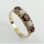 9ct gold garnet and opal five sone ring, 2.5 grams, Birm. 1967, Size P, 5mm wide. UK Postage £12