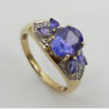 9ct gold tanzanite and white spinel ring, 3.2 grams. Size O 1/2, 8.4 mm. UK Postage £12.