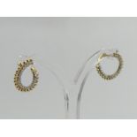 A pair of 9ct gold diamond set earrings, 2.1 grams. 9 mm diameter. UK Postage £12.
