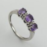 9ct white gold purple sapphire and diamond ring, 2.3 grams, size N 5.2mm wide. UK Postage £12.
