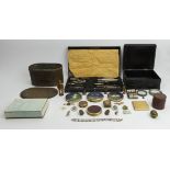 A lacquer box containing six vintage compacts along with an old tin of buttons and a leather stud