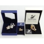 Three Swarovski crystal brooches and a dragon pin, largest dragon brooch 50mm. UK Postage £12.