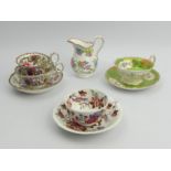 A Minton Chinese tree design tea cup, coffee cup and saucer, a floral cream jug and two cabinet cups