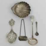 Silver butter dish, sifter spoon, salt spoon and an ornate spoon, along with a decanter label,