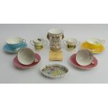 Four Aynsley Pembroke tea cups and saucers and four bone china commemorative items. UK Postage £15.