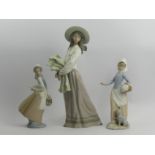 A group of three Nao china figures of young women, tallest 39cm. UK Postage £18.