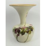 Doulton art pottery vase hand painted with a fruiting and flowering vine design on an off white