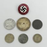 Various German swastika coinage and an enamel National Socialist badge. UK Postage £12.