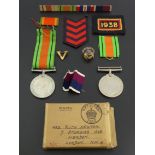 Two World War II defence medals, various ribbons, other insignia and a British Legion badge. UK