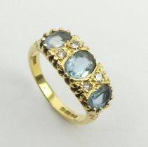 18ct gold three stone aquamarine and diamond ring, London 1979, 5.5 grams, 8.2mm size P. UK