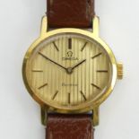 Ladies Omega gold tone manual wind watch on a leather strap. 25 mm wide. UK Postage £12. Condition