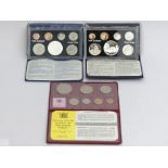 Two New Zealand proof coins issues with silver one dollar coins and a 1975 souvenir coin set. UK