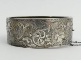 George V silver engraved bangle, Birm. 1913, 33.9 grams, 25mm wide. UK Postage £12. Condition