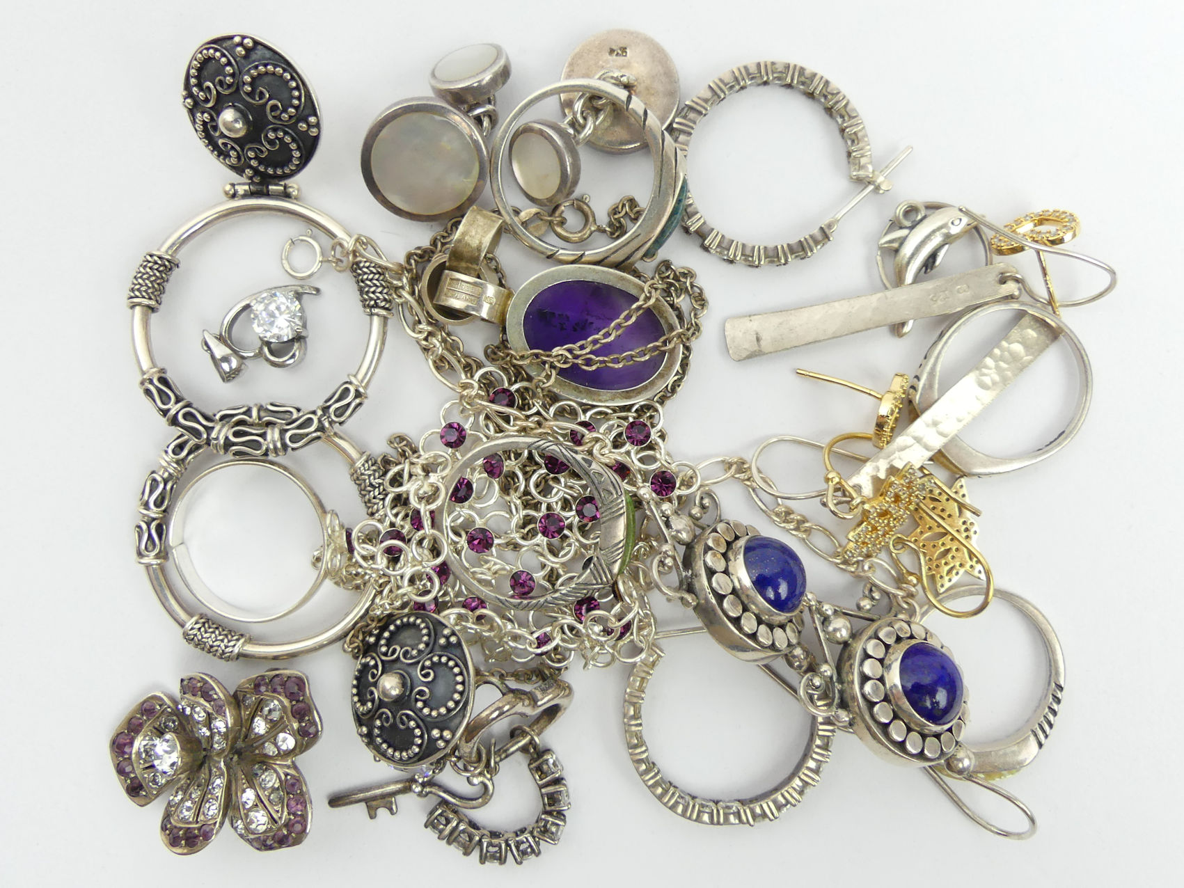 Various items of silver jewellery including rings, stone set pendants, ornate earrings and a stone