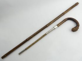 A Brigg bamboo walking stick with a kosh inside and a silver collar, London 1920, 97cm. UK