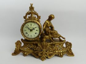 Ornate brass figural mantel clock, striking on a bell, 30cm x 37cm x 18cm. UK Postage £20.