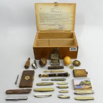 A box of miscellaneous items including pocket knives and a stanhope. UK Postage £14.