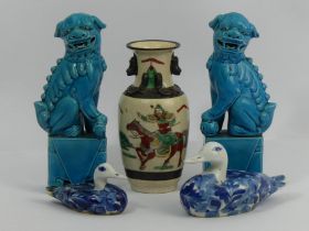 A pair of Chinese turquoise glazed temple lions, a Chinese crackle ware warrior vase and two