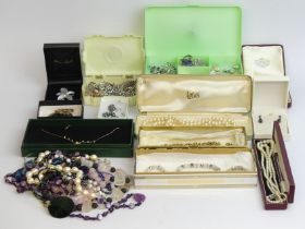 A collection of costume jewellery including beads and brooches. UK Postage £15.