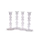 ATTRIBUTED TO BACCARAT: A SET OF FOUR CUT GLASS CANDLESTICKS